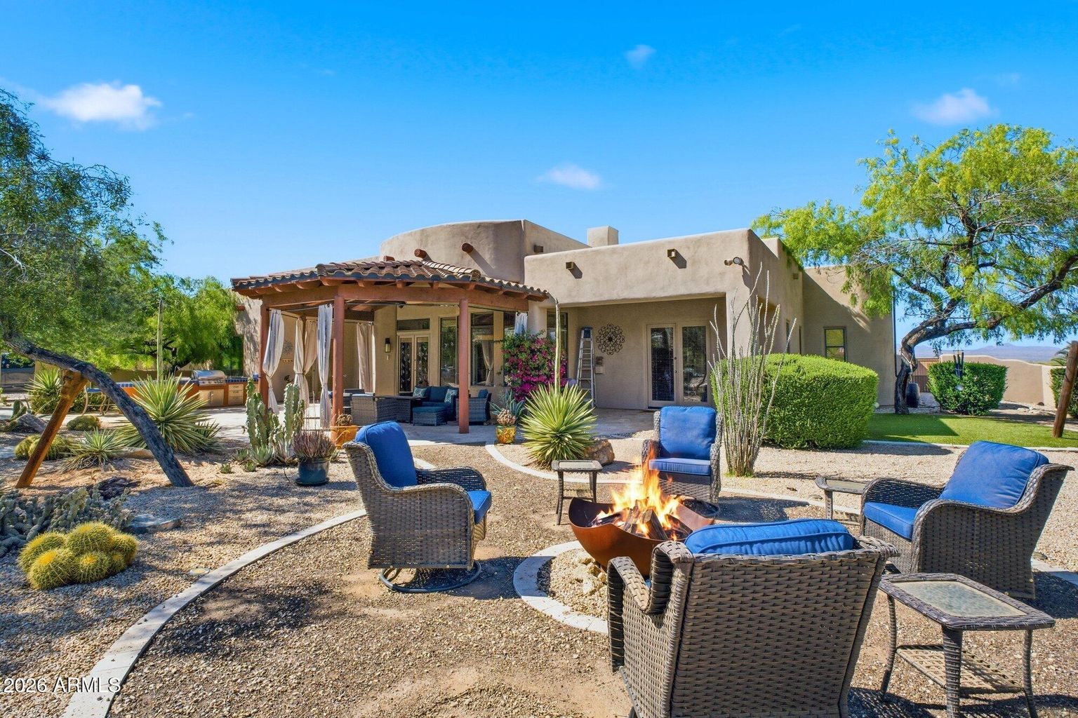 Aerial-style view of 13919 E Quail Track Road showing the main residence, the detached casita, the saltwater pool, and the 1.25-acre block-walled grounds surrounded by Sonoran desert