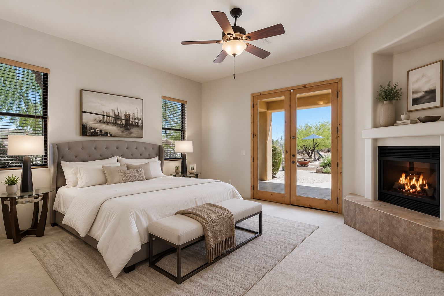 Front elevation of 13919 E Quail Track Road, a Santa Fe-inspired adobe-style residence with viga beams, a clay-tiled portico, and a desert-landscaped approach in the Rio Verde Foothills of Scottsdale